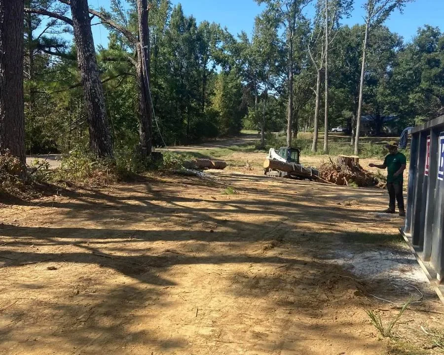 Skid steer working on a cleared lot